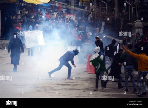 A Kashmiri Muslim protester throws stones at Indian policemen during ...