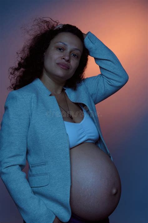 Beautiful Multi Ethnic Pregnant Woman Looking At Camera Posing With