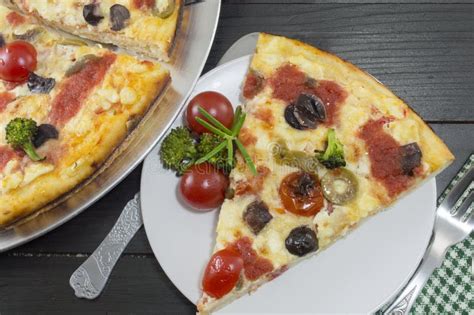 Vegetarian Pizza Slice Served With Cherry Tomato And Broccoli Stock