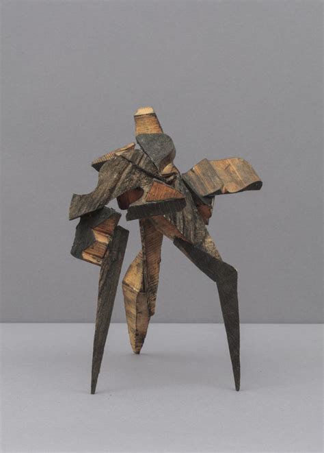 An Abstract Sculpture Made Out Of Wood With Multiple Pieces Of Wood