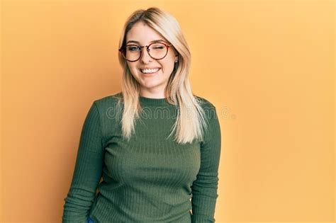 Young Caucasian Woman Wearing Casual Clothes And Glasses Winking