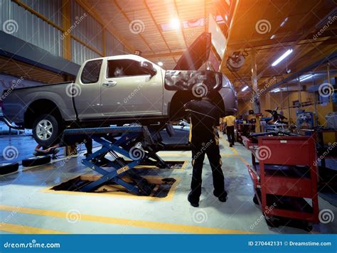 Car on Hydraulic Lift in Auto Repair Shop Stock Image - Image of ...