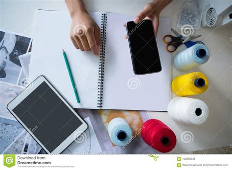 Fashion Designer Using Mobile Phone At Desk Stock Image Image Of