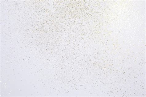 Premium Photo | Gold glitter scattered on white background