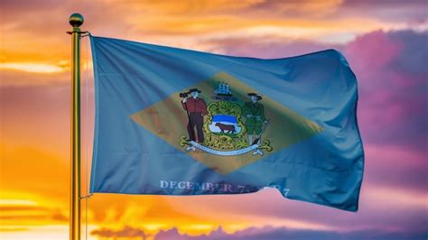 Delaware Waving Flag Against A Cloudy Sky Premium AI Generated Image