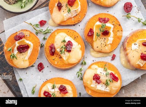 Baked Sweet Potato With Brie Cheese Cranberry And Walnut Stock Photo