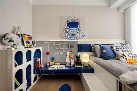 A Room With A Bed Desk And Shelves Filled With Toys On It S Sides