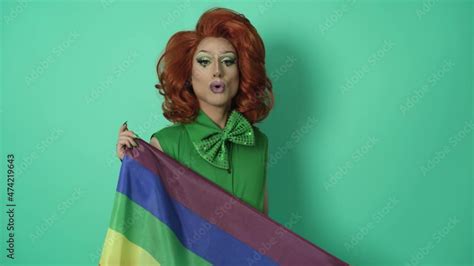 Drag queen celebrating gay pride holding rainbow flag symbol of LGBTQ social movement Stock ビデオ
