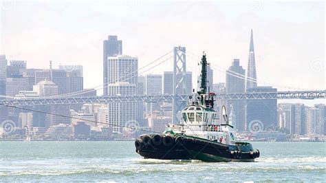 Tugboat America Assisting Cargo Ship To Maneuver Through The San