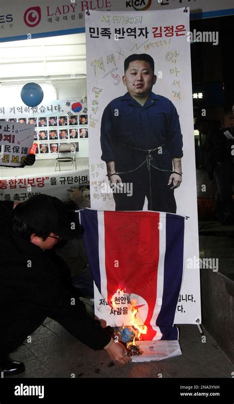 A South Korean Protester Burns A North Korean Flag In Front Of A Picture Of North Korea S New