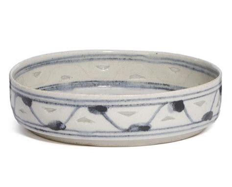 A Circular Stoneware Dish With Incised Relief Decor And Openwork