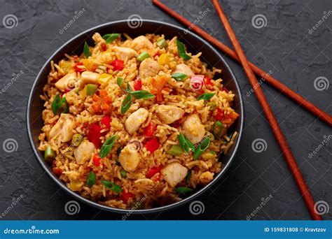 Schezwan Chicken Fried Rice In Black Bowl At Dark Slate Background