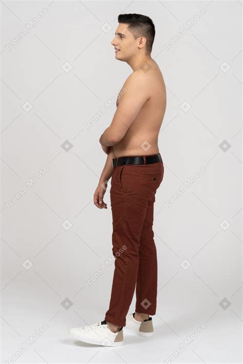 Side View Of A Shirtless Latino Man Looking Shy Photo