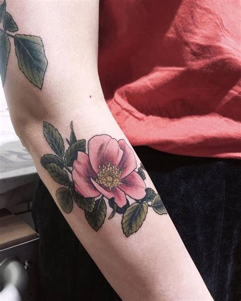 Dog rose tattoo located on the forearm, illustrative