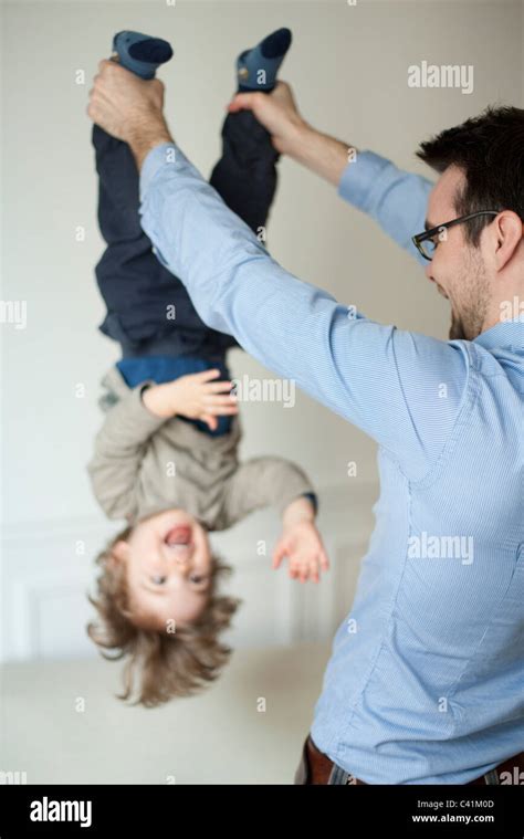 Dad Holding Kid Upside Down