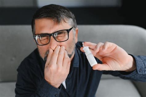 Portrait Of Man With A Nasal Spray Sick Man Using Nose Drops While