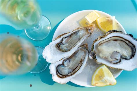 Fresh Oysters Close Up On A White Plate Served Table With Oysters Lemon Healthy Sea Food