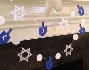 A Mantle Decorated With Paper Cutouts And Decorations For Hanukkah On