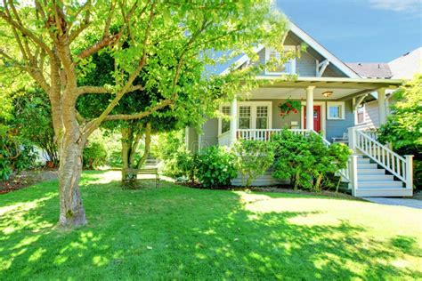 American House With Beautiful Landscape And Vivid Flowers Stock Image