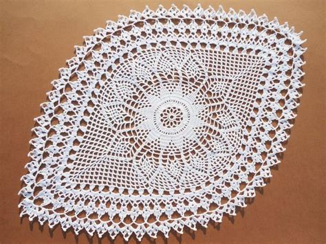 A Crocheted Doily On A Brown Surface