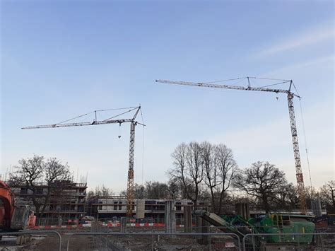 Pedestrian Operated Tower Cranes Working Together On Site