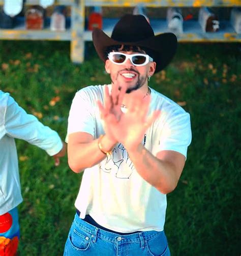 Two Men In Cowboy Hats And Sunglasses Are Clapping