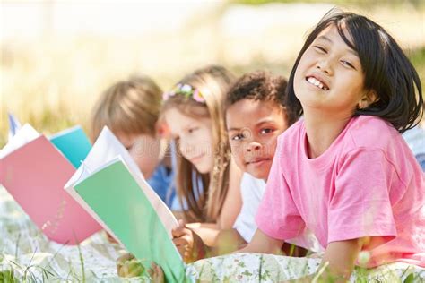 Grupo De Niños De La Escuela Primaria Que Aprenden a Leer Imagen de