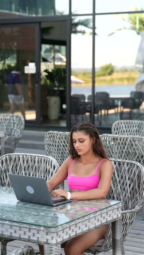 Woman In Bikini Sits Outside Using A Laptop 13153546 Stock Video At