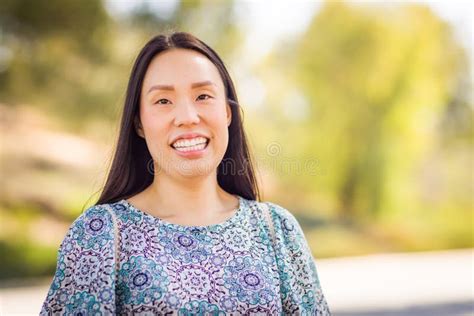 Outdoor Portrait Of A Happy Chinese Young Adult Woman Stock Photo