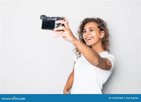 Portrait Of A Smiling Young Latin Woman Taking Selfie With Photo Camera