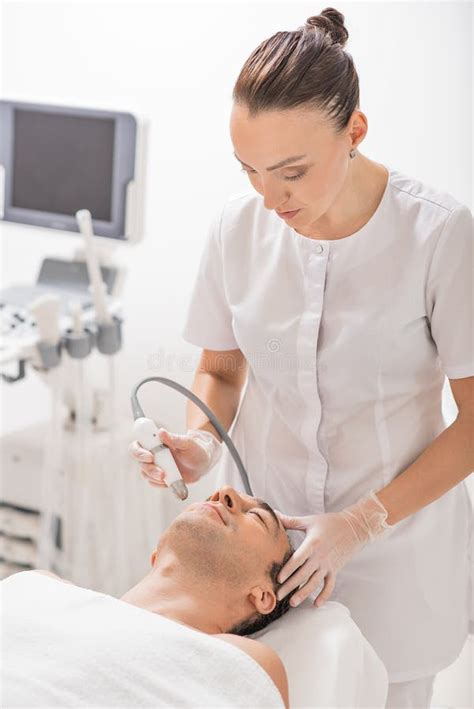 Cosmetician Undergoing Ultrasound Cavitation Massage Stock Image