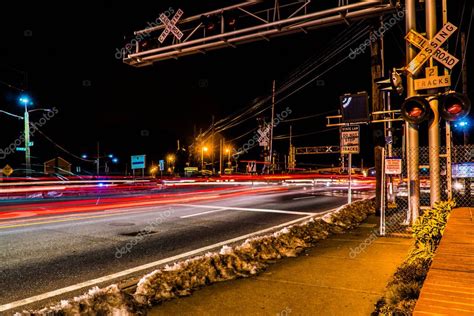 Traffic passing railroad crossing tracks on a busy road during rush ...