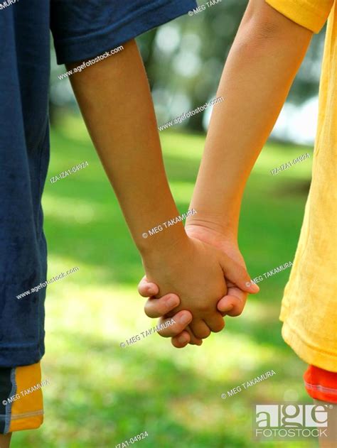 Mid Section View Of Two Boys Holding Hands Stock Photo Picture And