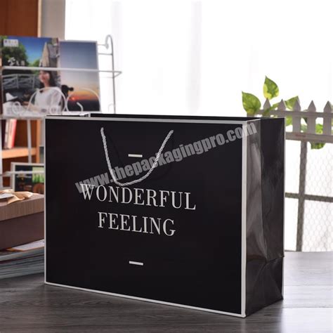 New Gold Logo Hot Foiled Stamping Black Matt Kraft Paper Bag Custom Print Luxury Packaging