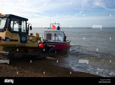 Fishing Boat Being Launched From The Beach By Tractor Hastings UK