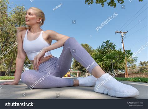 Healthy Fit Atrractive Blonde Woman Seated Stock Photo