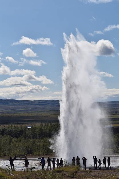Premium Photo People Standing By Hot Springs Against Sky