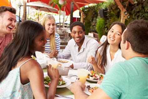 Group Of Friends Enjoying Lunch In Outdoor Restaurant Stock Image