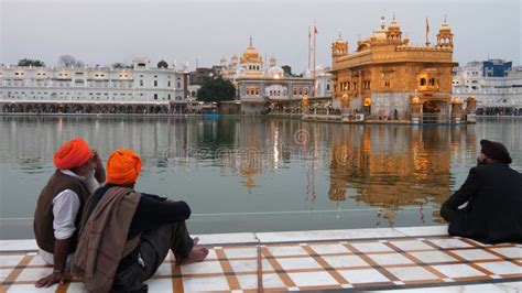 Three Men Sit By The Pool At Golden Temple In Amritsar K P Stock