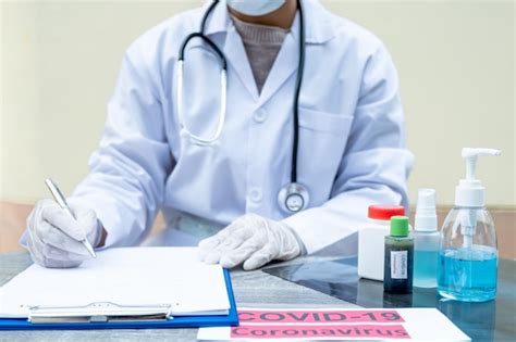 Premium Photo Midsection Of Doctor Writing On Paper In Office