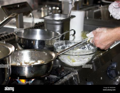 Cooking In Professional Restaurant Kitchen On The Stove With Fire In