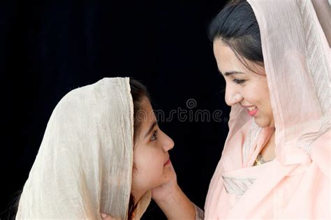 Portrait Of Adorable Smiling Pakistani Muslim Girl With Beautiful Eyes And Her Mother Wearing