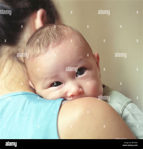 Baby Looking Over Mother S Shoulder Stock Photo Alamy