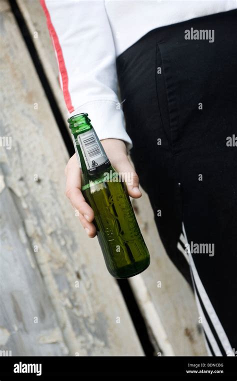 Close Up Of A Beer Bottle Being Held By A Teenage Girl Stock Photo Alamy