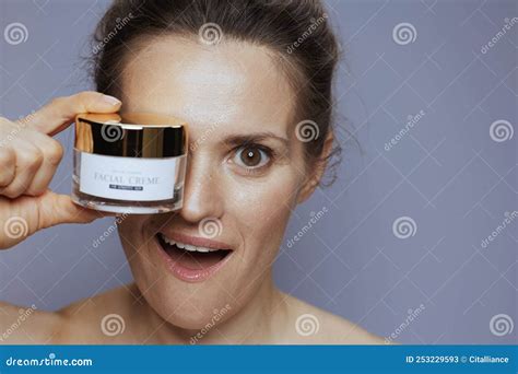 Surprised Young 40 Years Old Woman With Cosmetic Cream Jar Stock Image