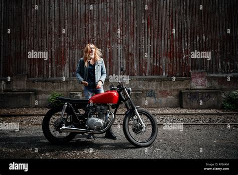 Confident Young Woman Standing Next To Motorcycle Stock Photo Alamy
