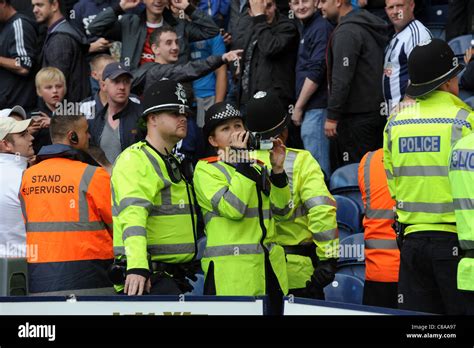 West Midlands Police Officers Videoing Football Crowd At Football Match