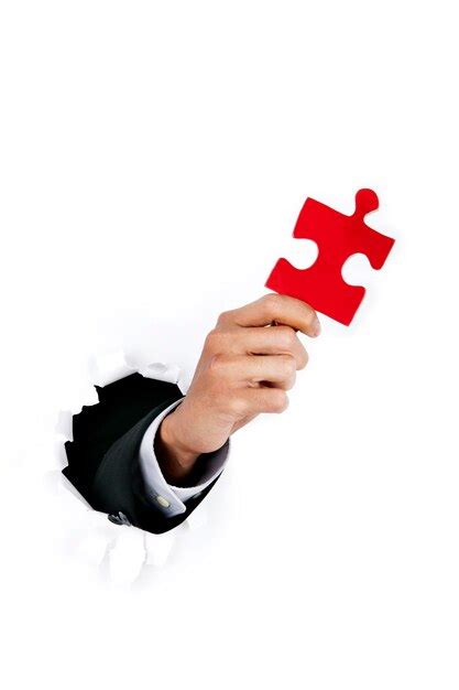 Premium Photo Cropped Hand Of Person Holding Jigsaw Piece Coming Out