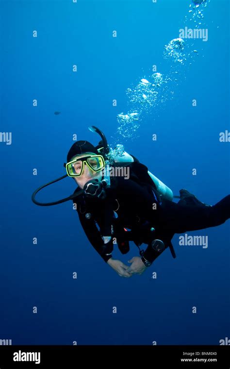 Scuba Diver On A Tropical Coral Reef Off Bunaken Island In North