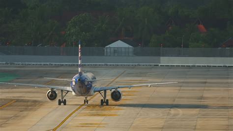 Airplane Taxiing On The Airfield Rear View Air Carrier On Taxiway